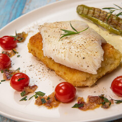 FISH RECIPE, SAINT-PIERRE SEAFISH, FILLET ACCOMPANIED BY PANNE RICE, THAI AUBERGINE, TOMATO, SHALLOT, TARRAGON AND CREAMY SAUCE WITH MUSTARD AND LEMON. High quality photo