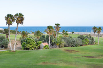Obraz premium extensive 18 holes golf courses spreading between the tranquil resort with the same name and a small harbor known as Marina San Miguel at Amarilla Golf, Tenerife, Canary Islands, Spain