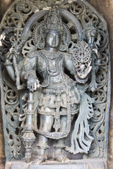 An Artistic view of the Sculpture carving of a Hindu Court Dancer in fine detail at the Belur Chennakeshava temple in Karnataka, India.
