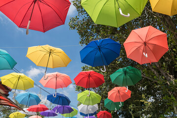 Fototapeta na wymiar colorful umbrellas hanging on rope to decor outdoor