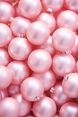 Christmas pastel pink baubles closeup. Abstract holiday decor background