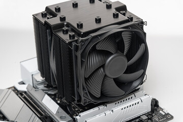 Installing a large air cooler on a computer processor.