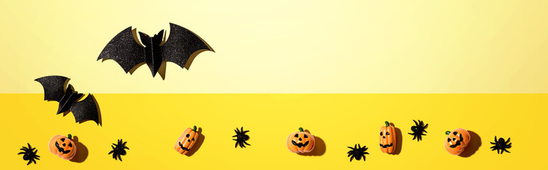 Halloween paper bats and small pumpkin ghosts - flat lay