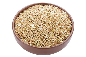 Unroasted buckwheat in a bowl. Useful dietary product. Isolated on a white background.