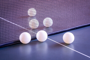 Table tennis balls on a blurred background.	