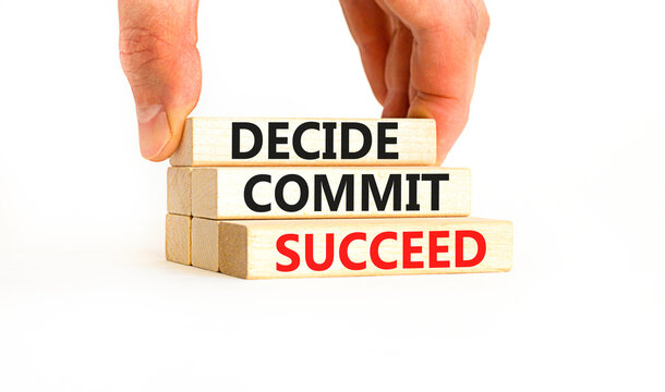 Decide commit succeed symbol. Concept word Decide Commit Succeed on beautiful wooden block. Businessman hand. Beautiful white table background. Business decide commit succeed concept. Copy space.