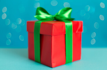 Christmas gift on table against blurred lights