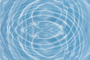 Blue water with ripples on the surface. Defocus blurred transparent blue colored clear calm water surface texture with splashes and bubbles. Water waves with shining pattern texture background.
