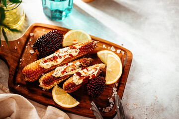 Baked whole corn with sauce and lemon