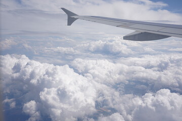 Fototapeta na wymiar Aerial view on cloudy skies from airplane window