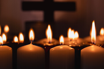 A memorial candle on a dark background. Burning candle on black background, copy space