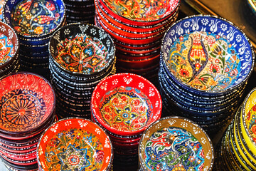 Stack of classical traditional Turkish ceramics, handmade colorful dishes at the Istanbul street...