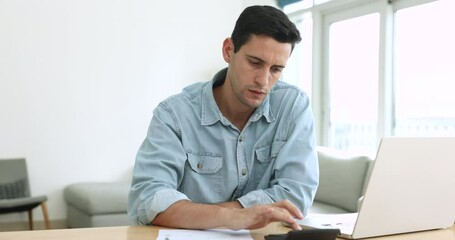 Concerned man calculate expenses, manage family budget, controlling personal finances, doing accountancy job, prepare financial report looks serious or troubled. Lack of money, debt, huge taxes to pay