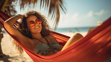 Naklejka premium Happy woman lies in a hammock against a backdrop of palm trees and the sea during a vacation