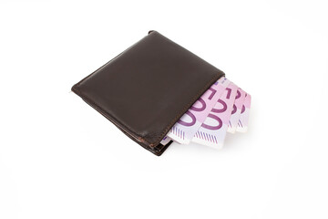 500 euro paper banknotes in a closed brown leather wallet, isolated on white