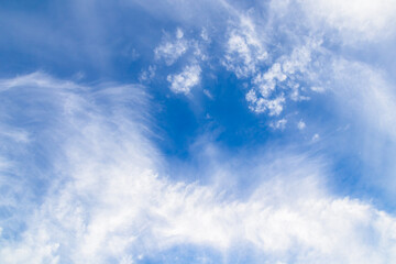 Dramatic white cloud on bright blue sky background.