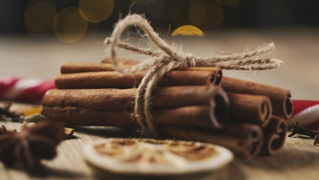 Close up view of romatic spices lying on round wooden plate