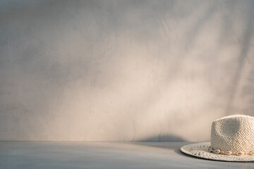 A straw hat on the table in the rays of the evening or morning sun. Rural or detective theme...