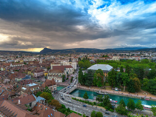 Obraz premium Annecy city center panoramic aerial view over the old town, castle, Thiou river and mountains surrounding the lake. Annecy is known as the Venice of the French Alps