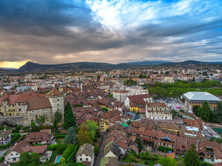 Annecy city center panoramic aerial view over the old town, castle, Thiou river and mountains surrounding the lake. Annecy is known as the Venice of the French Alps