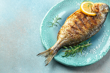 roasted dorado or sea bream fish with lemon, organic healthy products. Detox and clean diet...