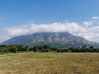 Monte Taburno veduta estiva con nubi sulla cima e foschia leggera