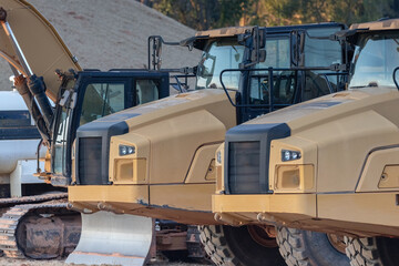 heavy-duty construction vehicles in a residential neighborhood, closeup of cab areas