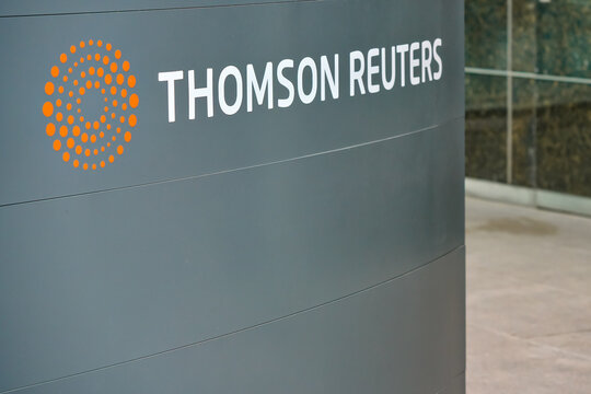 London, United Kingdom - May 18, 2023: Thomson Reuters sign at their offices building in Canary Wharf. TR Group is Canadian multinational mass media and information firm
