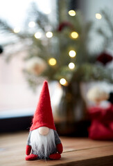holidays, decoration and celebration concept - close up of christmas gnome and fir branches in vase...