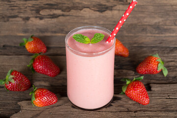 Strawberry yogurt fruit juice smoothie pink colorful fruit juice milkshake blend beverage healthy high protein the taste yummy In glass drink episode morning on wood background.