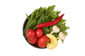 Plate with fresh vegetables on white background
