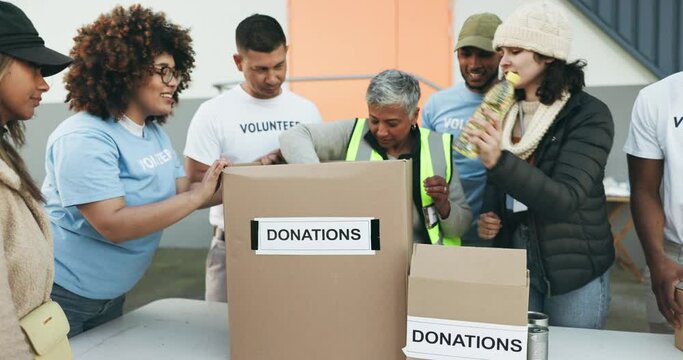 Happy people, volunteer and donation box in NGO, charity or team in community service together. Group of volunteering workers packing parcel, package or boxes in teamwork, society or contribution
