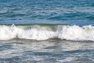 Rolling waves on sea, close-up, at clear day, selective focus .