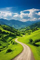 Fototapeta na wymiar Summer country road bordered by vibrant green mountains