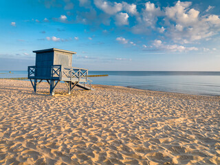 Lifeguard hut on beach at sunrise by Baltic Sea