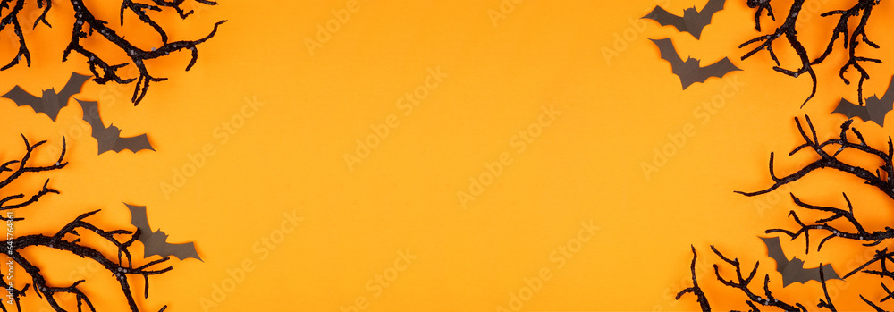 Aufkleber halloween double border of spooky bats and black branches. above view over an orange banner backgrou