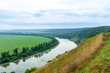 Fototapeta na wymiar Panorama of the Dniester River. Landscape with canyon, forest and a river in front. Dniester River. Ukraine