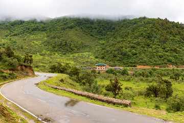 View of a winding road in a valley in Bhutan.