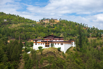 Fototapeta na wymiar Scenic view of a monastery on a hilltop in Bhutan with mountains in the background