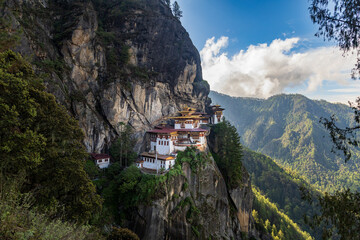 Scenic view of the sacred Paro Taktsang monastery (Tiger’s Nest buddhist temple) on the cliffside...