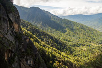 Beautiful view of a valley with trees and mountains in Bhutan, scenic panorama mountain summer landscape