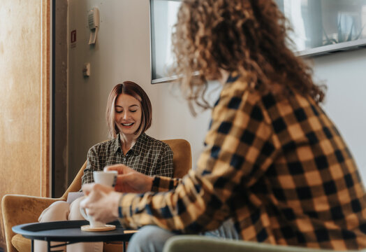 Friendship - lifestyle concept. Group of young and cheerful friends having fun in the cafe