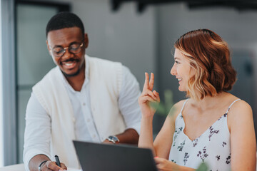 Group of colleagues in a modern office strategizing a marketing campaign, analyzing data, and...