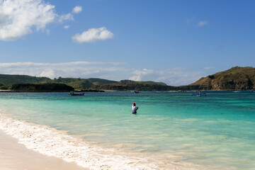 fishing on the beach, fisherman on the beach, traditional angler, local residents fishing on Lombok beach, tanjung aan beach lombok, fishing on the beach on a sunny day