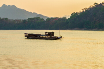 The contrast of Boats on the Mekong river, Luang Prabang, Laos in the afternoon with sunlight