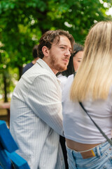 Man looking at his friend while they are sitting