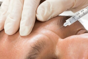 Man Receiving Cosmetic Injection With Syringe