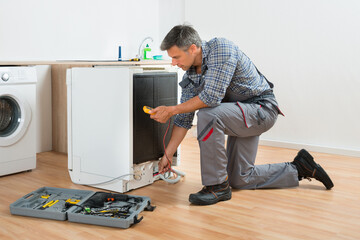 Technician Checking Dishwasher With Digital Multimeter