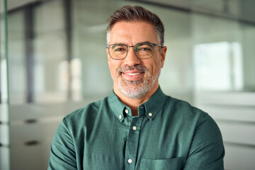 Smiling 45 years old banker, happy middle aged business man bank manager, mid adult professional businessman ceo executive in office, older mature entrepreneur wearing glasses, headshot portrait. - obrazy, fototapety, plakaty