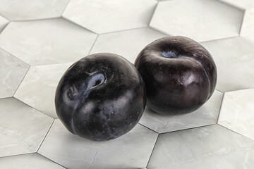 Two ripe sweet black plums